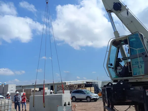 Grúa desplegada ejecutando una maniobra de izaje en el frente de obra